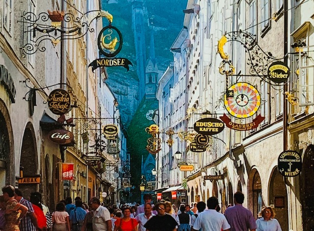 A group of people walking down a street

Description automatically generated